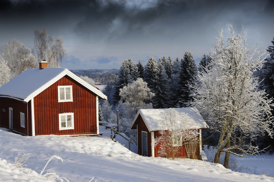 red cottages in winter scenery, sweden