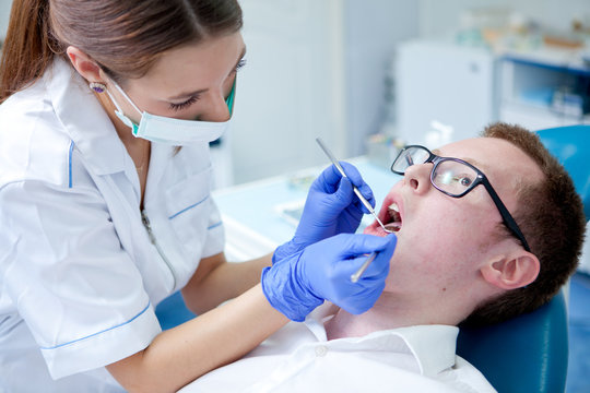 dentist at work on woman patient in office