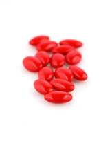 Obraz na płótnie Canvas red medicine pills on white