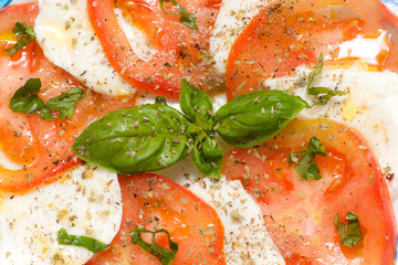 Caprese. Tomato and mozzarella salad with basil..