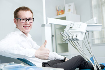 Naklejka na ściany i meble Happy patient at dentist office