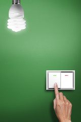 hand pressed to switch to turn on the light. - 42670923