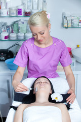 Two young women in cosmetic cabinet