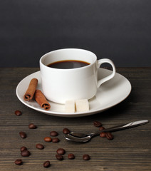 Coffee cup on wooden table on grey background