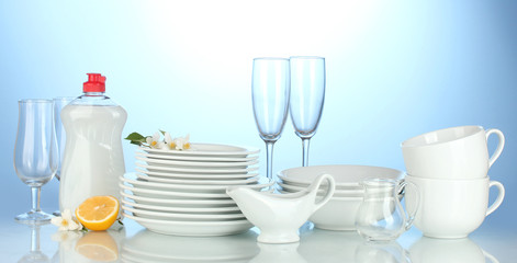 empty clean plates, glasses and cups with dishwashing liquid
