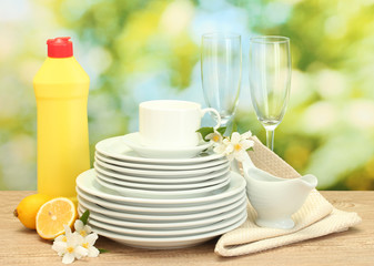 empty clean plates, glasses and cups with dishwashing liquid