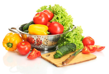 fresh vegetables and knife on cutting board isolated on white