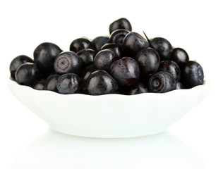 ripe blueberries in white bowl isolated on white