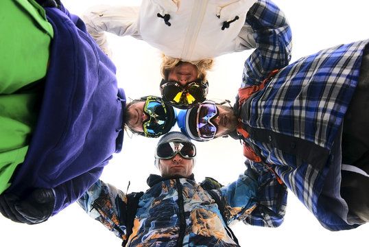 Snowboarders In Circle Looking Down