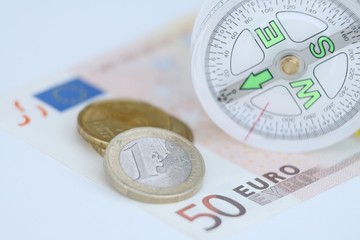 euro coins, euro banknote and compass