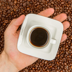 Cup of coffee on beans. top view