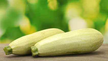 squash on wooden table on green background close-up
