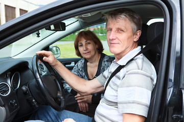 Senior Caucasian man and woman sitting in domestic car