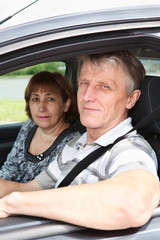 Close up of senior loving couple sitting in domestic car