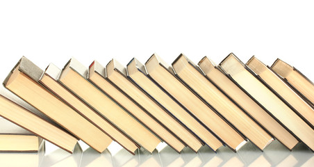 leaning stack of books on white background