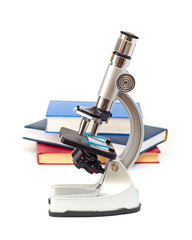 Microscope, books isolated on white