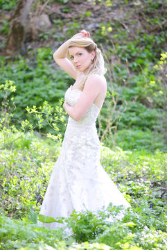 beautiful girl bride in green wood by summer