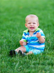 little boy playing on green grass