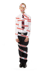 A man wrapped with adhesive tape with FRAGILE word
