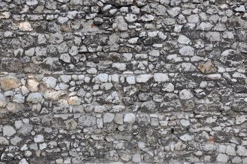 Stone wall background, dark limestone