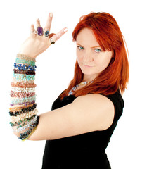portrait of young beautiful red woman with   bracelets on the ar