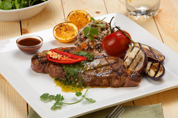Piece of Medium Rare Steak with Spicy Herb Sauce