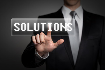 businessman pressing virtual solutions button