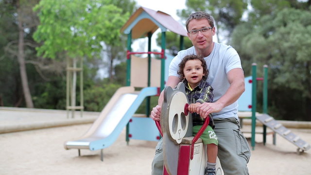 Father with little son having fun in the playground
