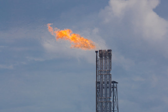 Burning oil gas flare during sunset