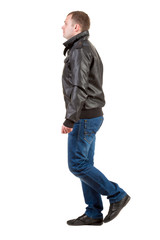 Naklejka premium Back view of going man in jacket.
