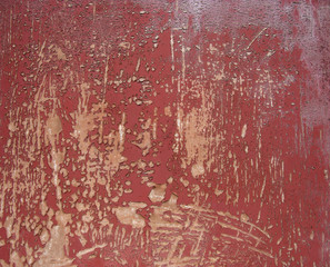 red peeling paint on timber
