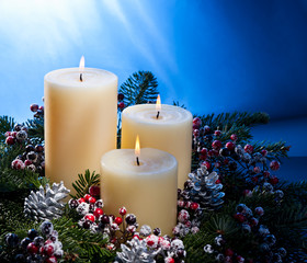 Three candles in an advent flower arrangement