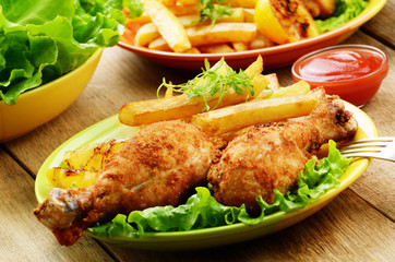 Fried drumsticks with french fries