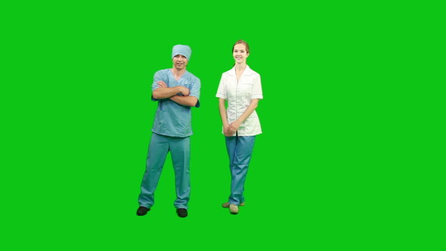Doctors standing and smiling. Green screen.
