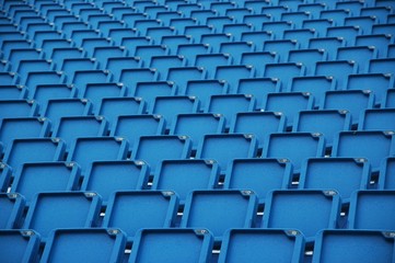 blue folding plastic seats at an outdoor event