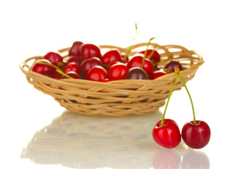cherry in wicker bowl isolated on white
