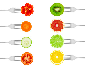 Fruits and vegetables on forks isolated on a white background