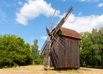 Fototapeta na wymiar old windmill on rural meadow