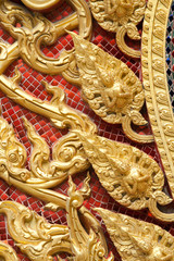 the gold stucco design of native thai style on the Wall