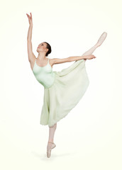 young beautiful ballerina on a gray background