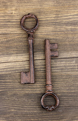 Two antique key on wooden background