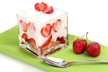 Glass of ripe strawberries with cream isolated on white