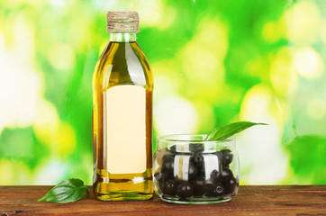 Olive oil bottle on green background