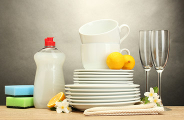 empty clean plates, glasses and cups with dishwashing liquid
