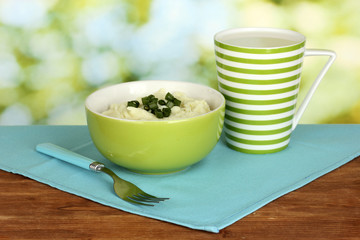 Mashed potato in the bowl and cup with milk