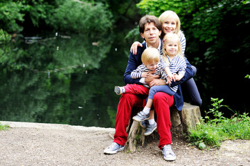 Happy parents with children posing outdoors