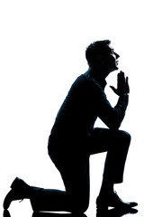 silhouette man kneeling praying  full length