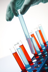  Scientist working in a laboratory , glass containing liquid col