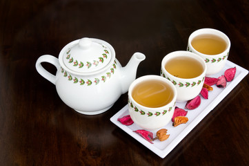 teapot and cup of tea with dry flowers