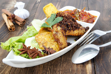 a plates of chicken dishes penyet